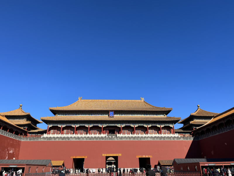 Front view of Meridian Gate at the Forbidden City beneath a clear blue sky.